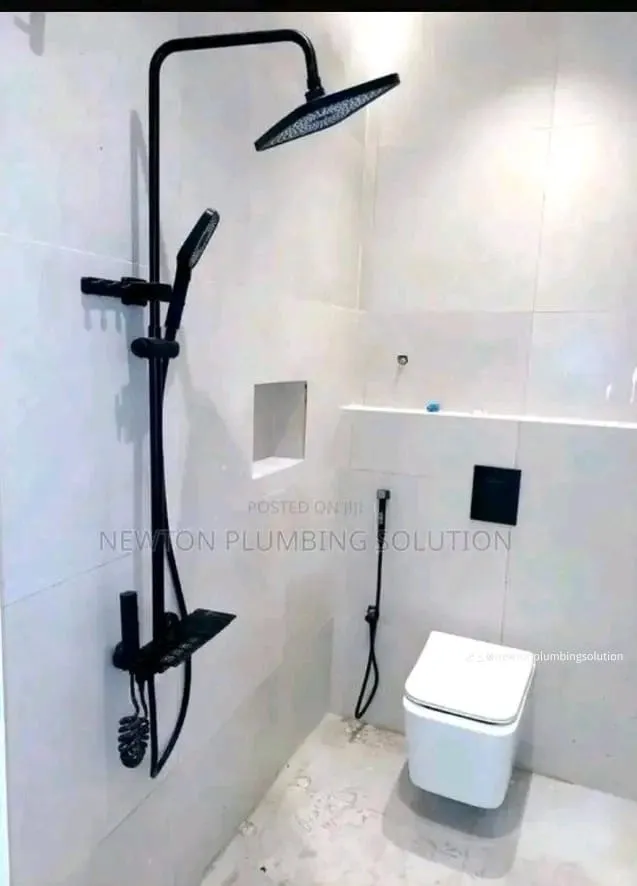 A finished bathroom installation with a rain shower and wall-mounted toilet